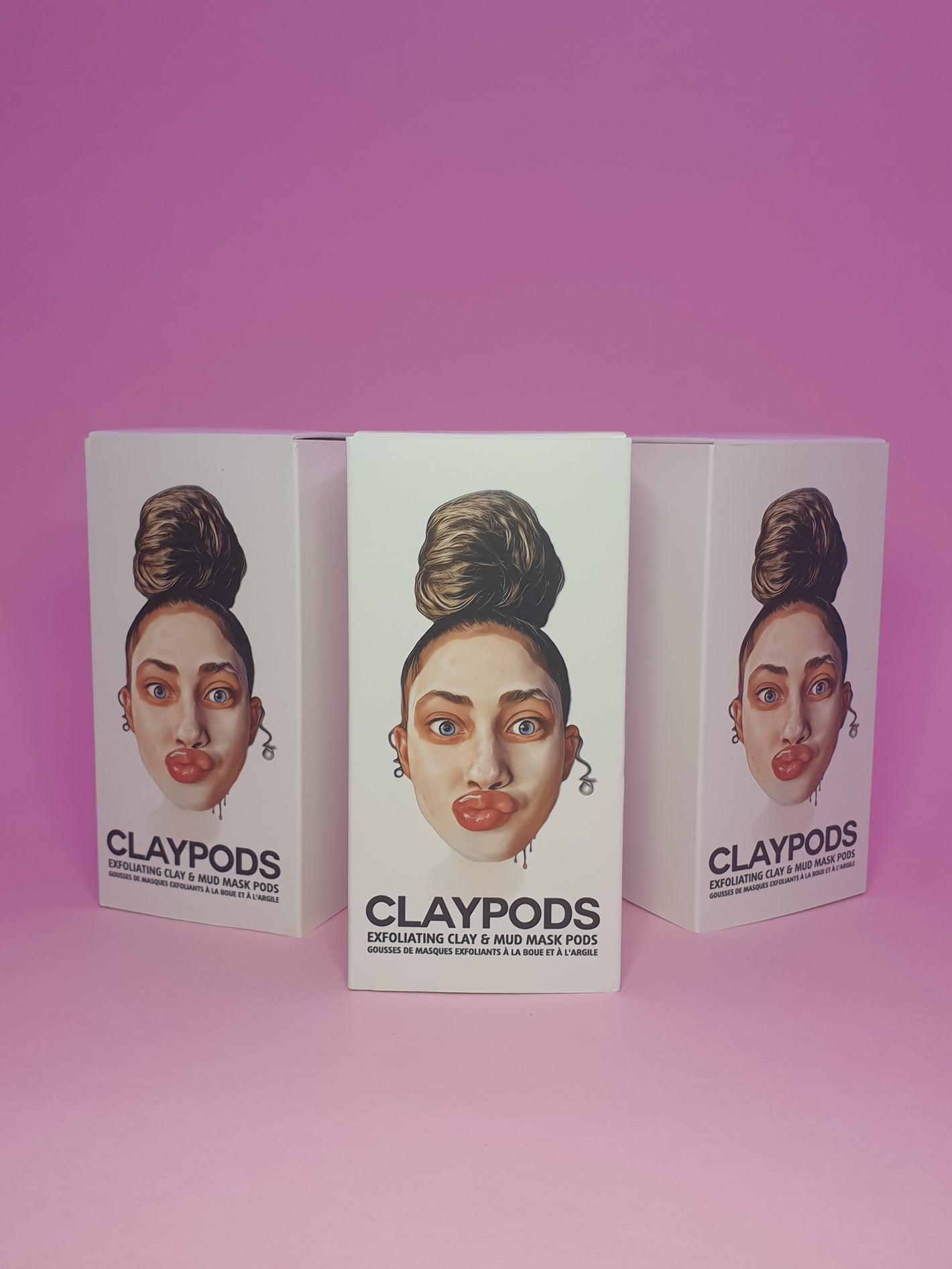 three boxes of clay pods on purple background