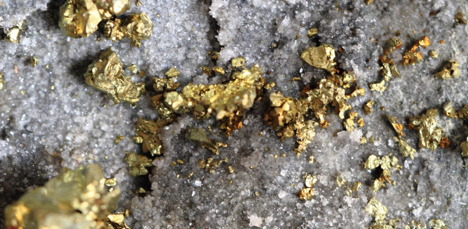Gold - A photo of a specimen of gold in its natural state. The gold may appear as nuggets, flakes, or grains and typically has a bright yellow or golden color. The gold may be found embedded in rocks, gravel, or sand, and may be found in various geological formations, such as quartz veins or alluvial deposits. 