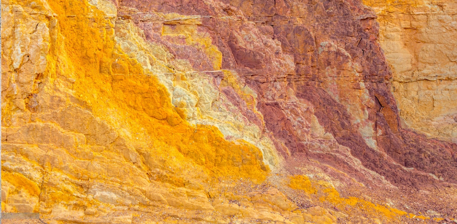 Australian yellow clay - A photo of Australian yellow clay in its natural state, as found in the earth. The clay has a soft, powdery texture and a bright yellow color that is reminiscent of sunflowers. Its surface is smooth and free of visible particles, giving it a uniform appearance.