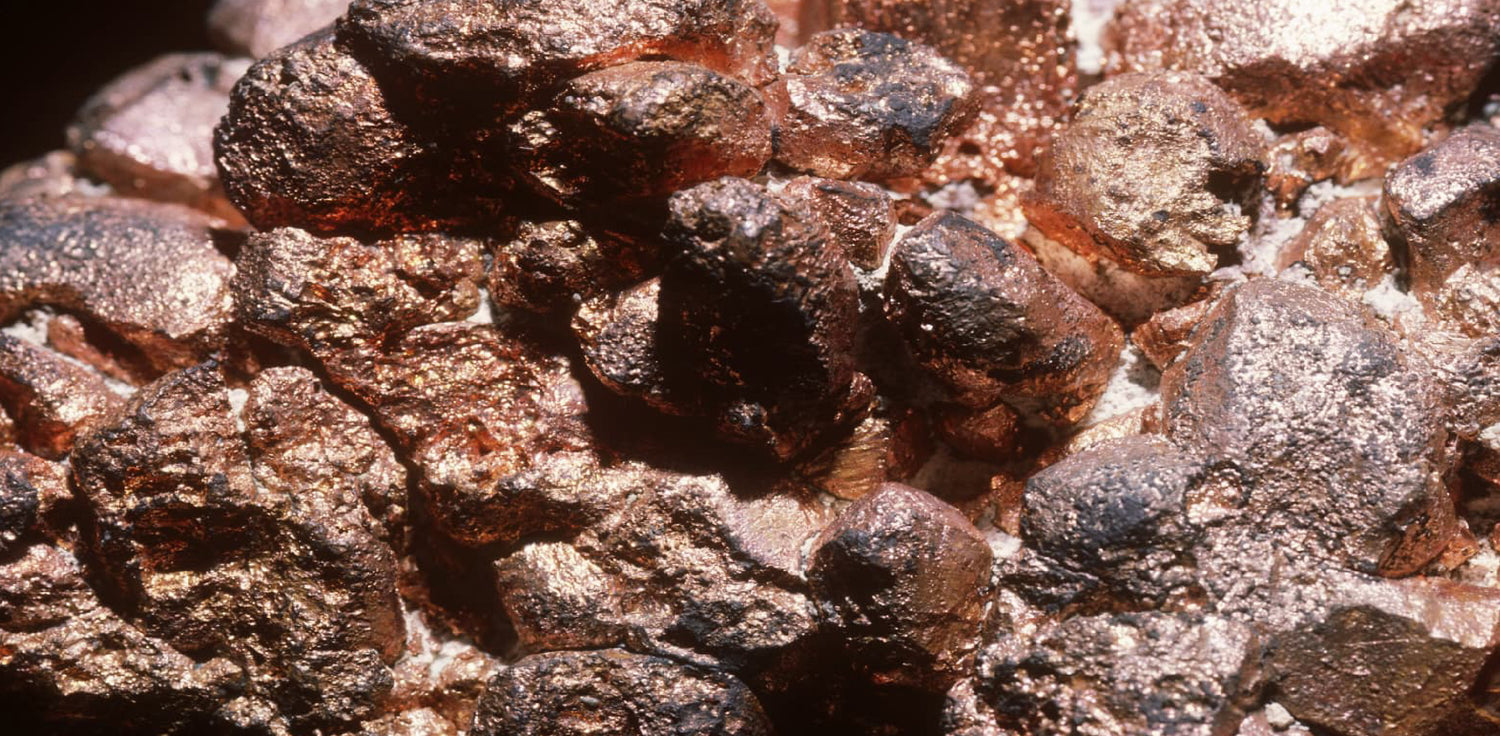 Copper deposit - A photo of a natural deposit of copper ore, a reddish-brown metal commonly used in various industrial and electrical applications. The photo shows an area with exposed copper ore, which appears as a mixture of rocks and minerals with a characteristic reddish-brown color. 