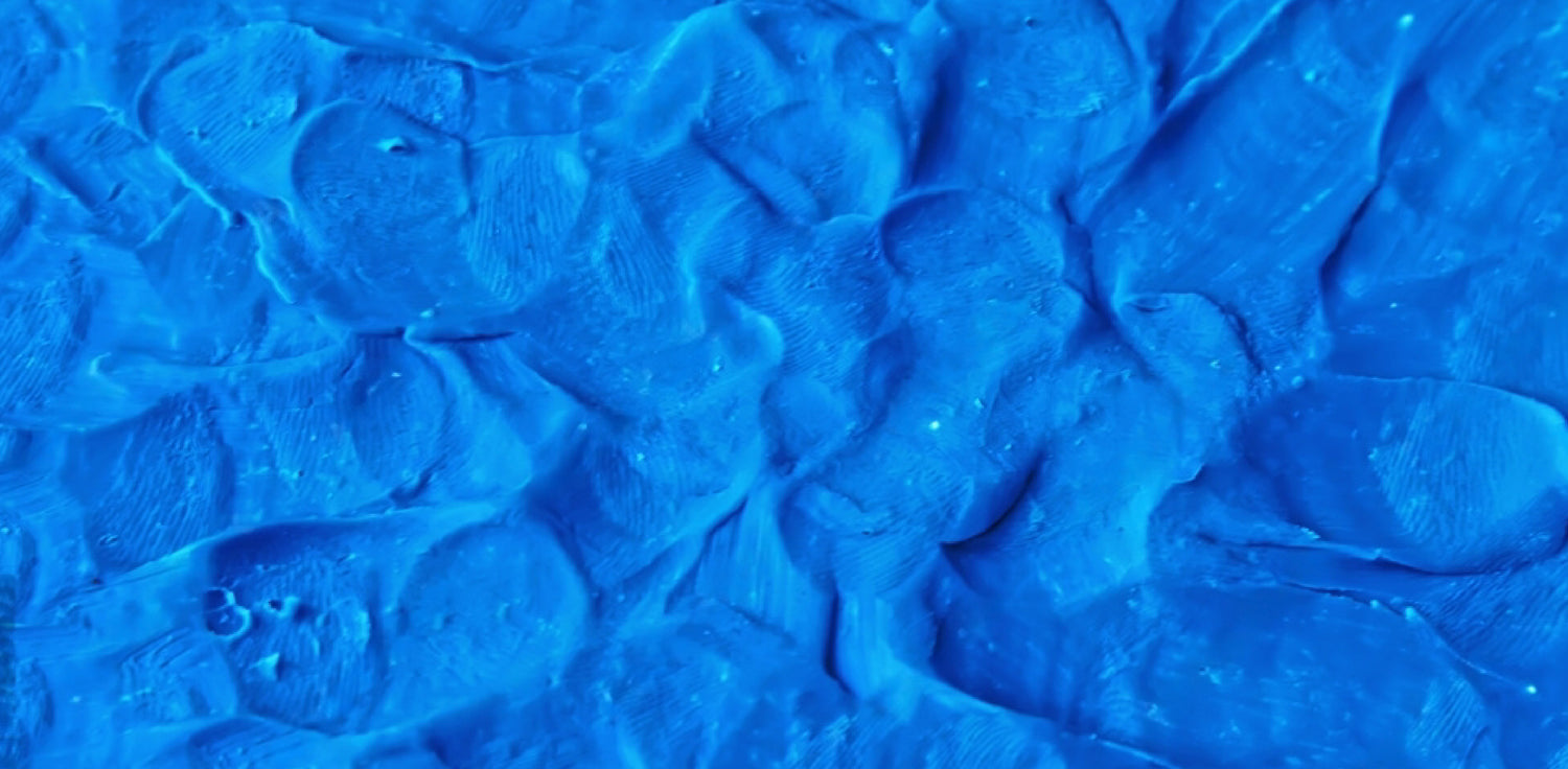 Synthetic Blue Clay - A photo of a jar of Synthetic Blue Clay, also known as Azure Blue Clay, which is a type of cosmetic clay that is artificially created. It has a distinct blue color that is achieved by combining natural clays with iron oxide and ultramarine blue pigments. This clay is commonly used in skincare products due to its unique color and detoxifying properties. 