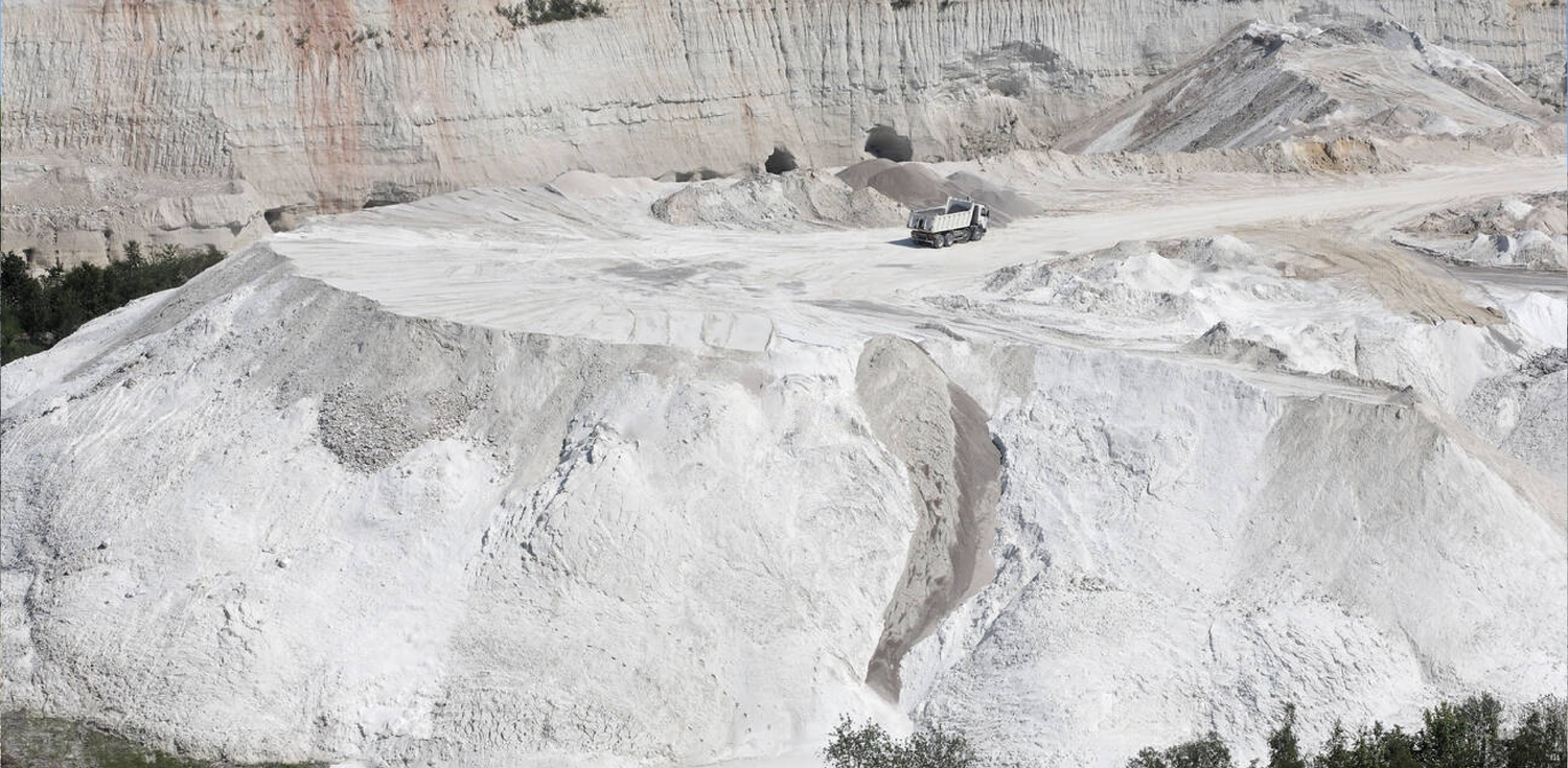 White China Clay - A photo of a container of White China Clay, also known as Kaolin clay. The clay is a fine, white powder that is widely used in cosmetics, skincare, and personal care products due to its gentle cleansing and exfoliating properties. The clay is derived from the mineral kaolinite and is known for its ability to absorb excess oil and impurities from the skin. It is also used as an ingredient in various other products, including paper, ceramics, and paint.