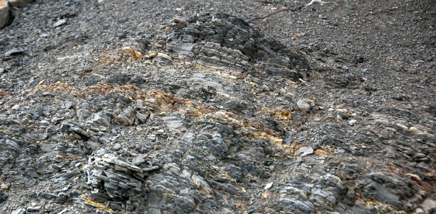 Volcanic Ash Clay - A photo of a jar of Volcanic Ash Clay, a type of clay that is derived from volcanic ash. The clay is known for its natural exfoliating and detoxifying properties, and is commonly used in skincare products to remove dead skin cells and impurities from the skin. The clay is rich in minerals and antioxidants, and is particularly effective at reducing inflammation and promoting skin regeneration. It has a dark grey color and a gritty texture, and is often used in facial masks and scrubs